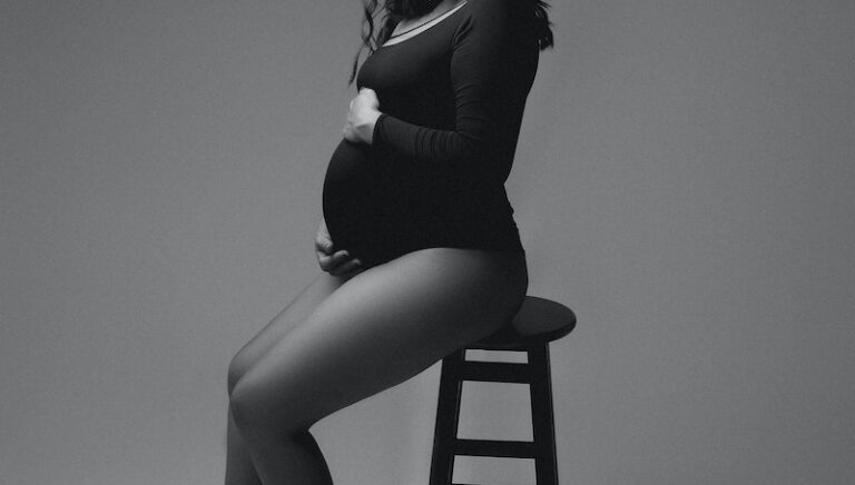 Pregnant Woman Posing on Stool in Studio